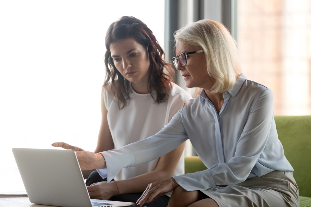 Female financial advisor and a female client looking at a laptop