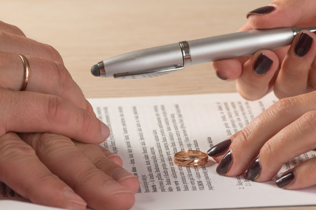 Woman signing papers without her ring