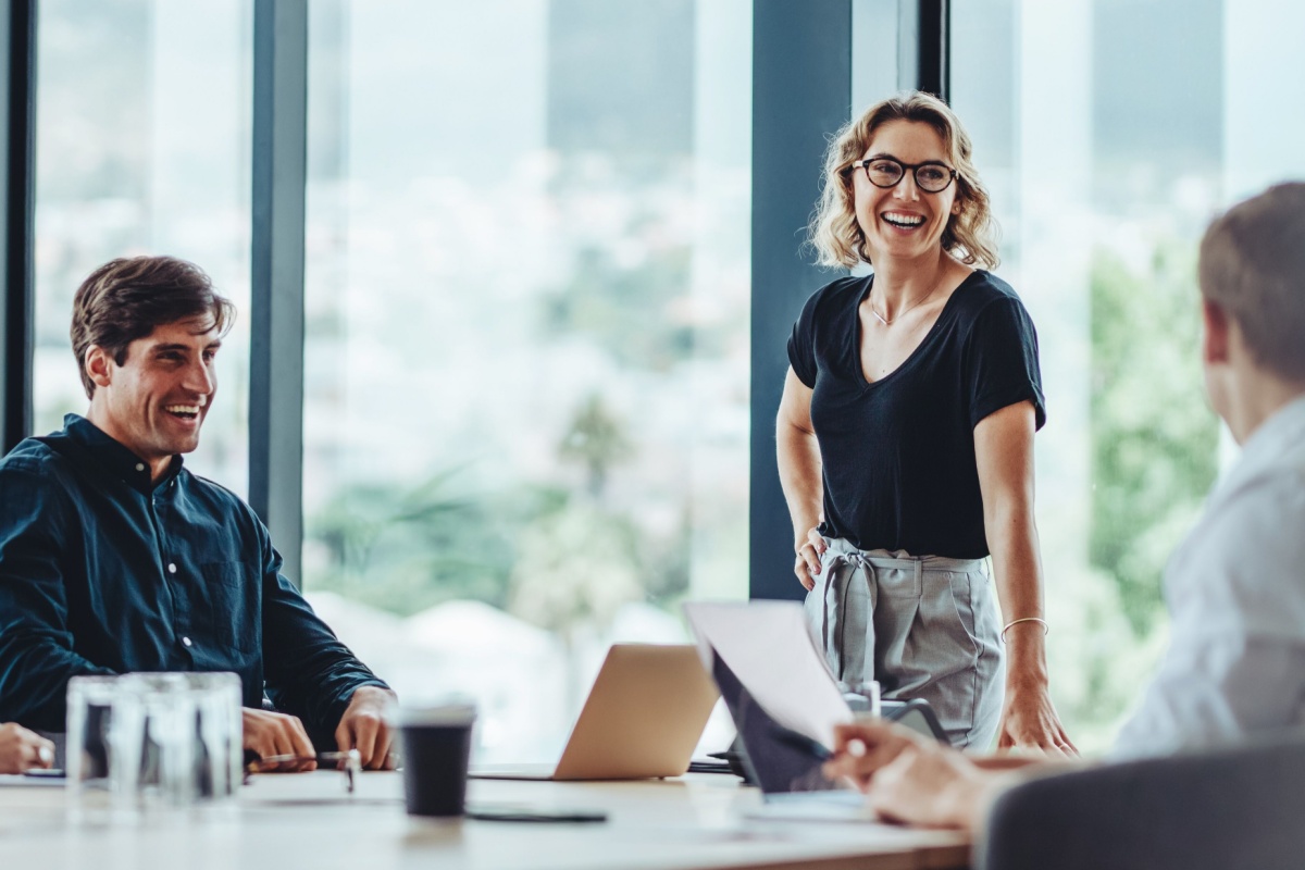 Happy businesswoman with colleagues in the office