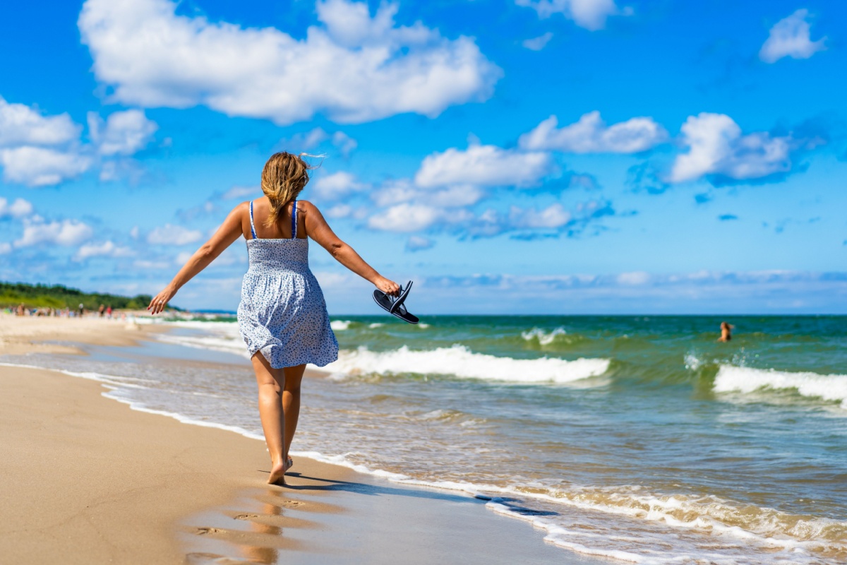 Middle-aged woman walking on a beach