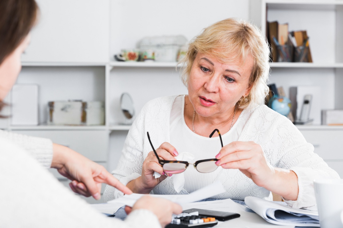Female financial adviser helping a mature woman review her finances