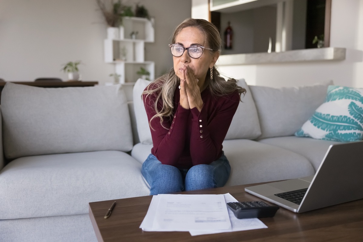 A stressed woman reviewing paperwork